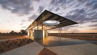 “Standing beneath the roof there is a sense of something quite modernist and soaring, yet viewed from a distance the building conveys another language of road-building and agricultural sheds.”